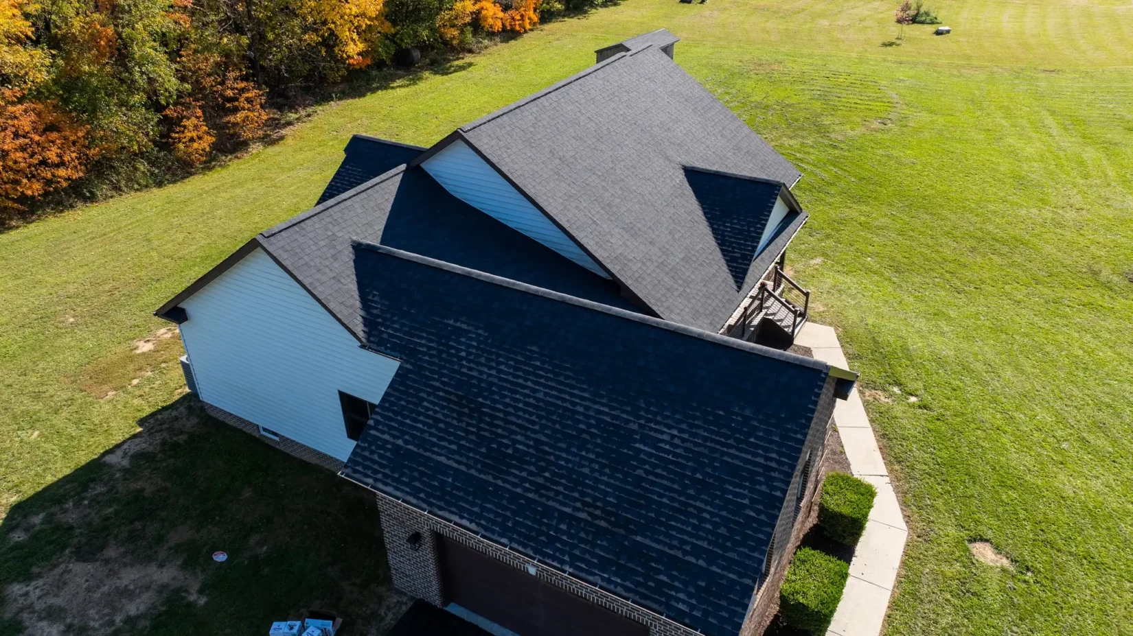 Aerial view of a gray roof installed on a white residential home showcasing roofing services in Martinsburg and Hagerstown