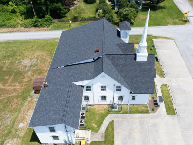 Aerial view of a grey roof installed on a white church