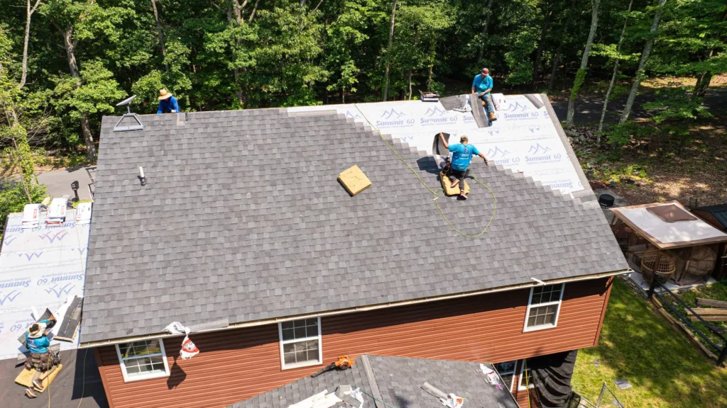 High Point workers installing a grey roof on a residential building, part of our about page